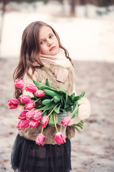 Child girl with bouquet of tulips — Stock Photo, Image