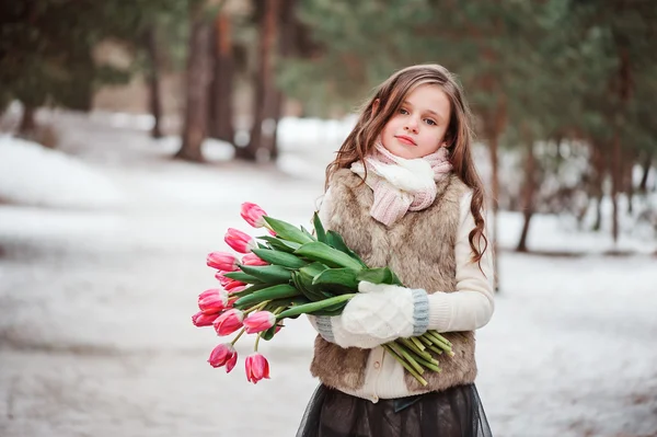Child girl with bouquet of tulips — Stock Photo, Image