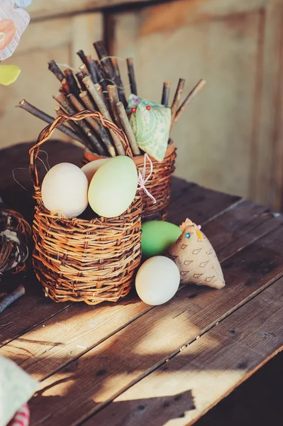 Easter eggs and decorations on wooden table in cozy country house, vintage toned — 图库照片