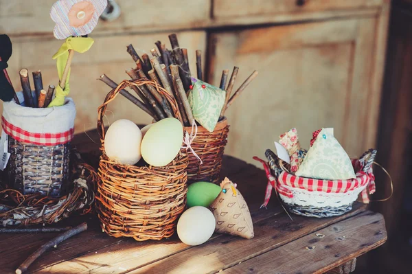 Easter eggs and decorations on wooden table in cozy country house, vintage toned — 图库照片