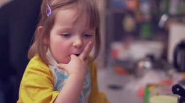 Güzel küçük kız mutfakta yemek yapmayı öğreniyor.