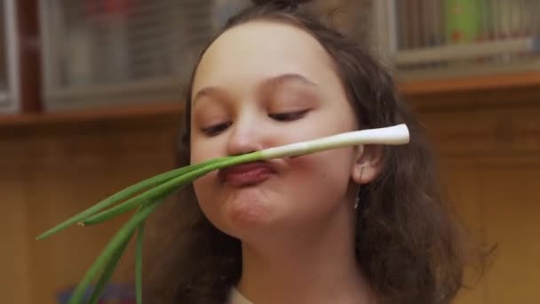 Teenager girl making mustaches with Scallions at kitchen — Stock Video