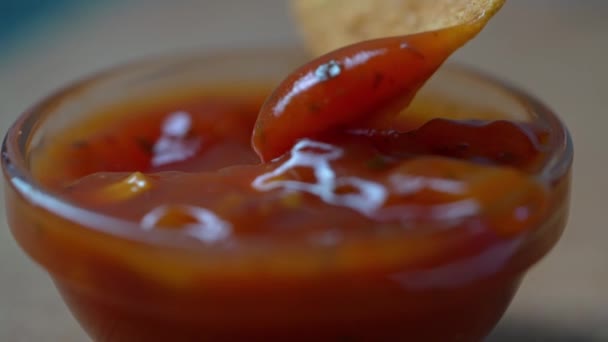 Close-up of dipping Tortillas chip in salsa sauce — Stock Video