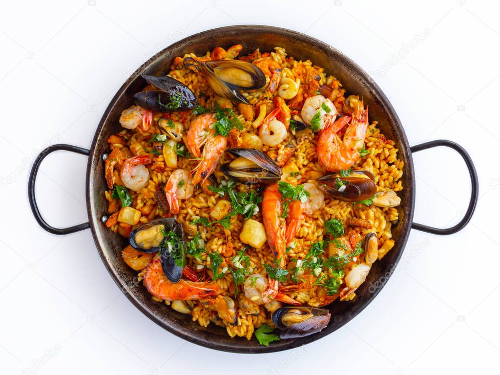 Traditional spanish seafood paella in the fry pan on a white background