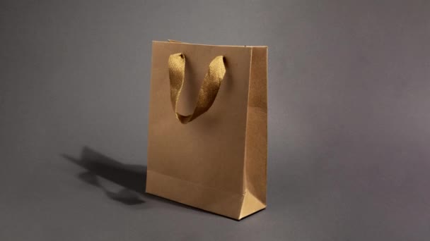 Stop motion animation with Craft paper shopping bag on dark background — Stock Video