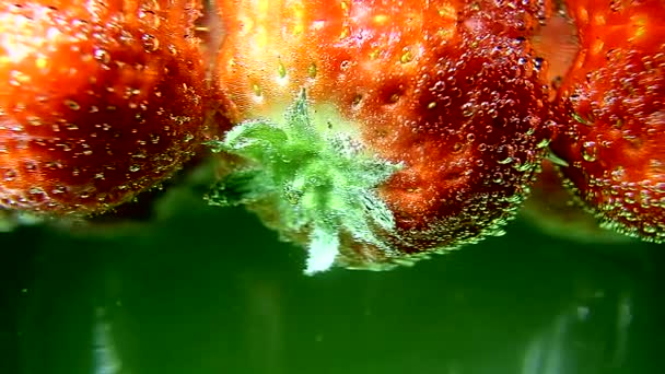 Ягоды, клубника в воде с пузырьками — стоковое видео