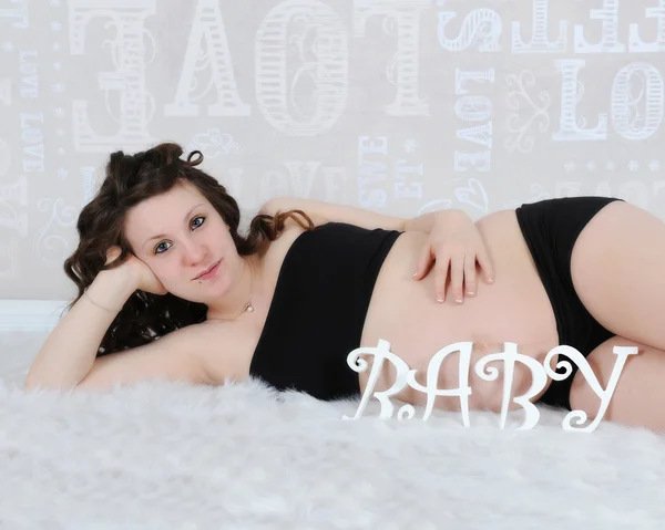 Bebekle döşeme güzel hamile kadın harflerle yazıldığından — Stok fotoğraf