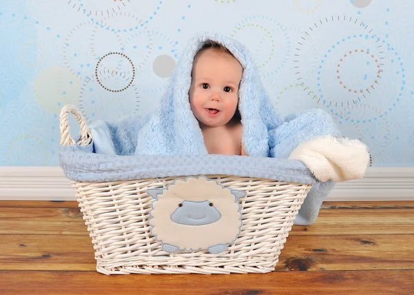 Şirin bebek çocuk battaniye baş üstünde sepetle oturan — Stok fotoğraf