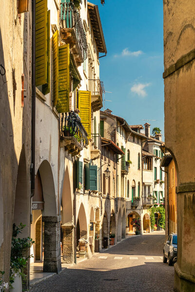 View of the arcades of the ancient village of Asolo in summer, Treviso, Italy