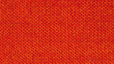 Arka plan olarak kullanılacak kumaş dokusunun yakın plan fotoğrafı. Kumaş kırmızı ve turuncu ipliklerin karışımından yapılmıştır. Sentetik ve yün karışımı. Soyut desen.