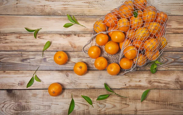 Tangerines on a wooden background — Stock Photo, Image