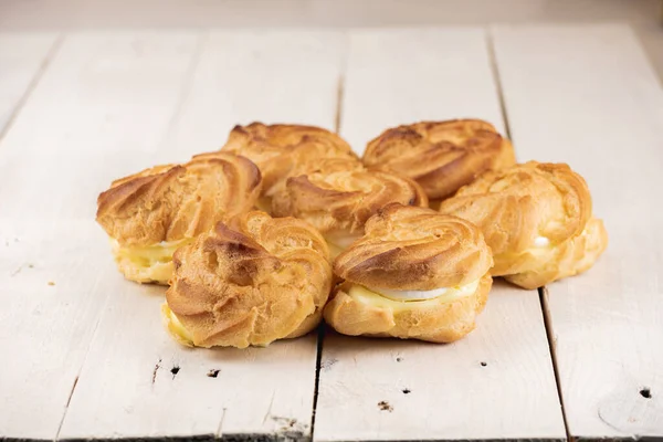 Profiterole Cakes White Wooden Table Creamy Filling Crunchy Dough Bottom — Stock Photo, Image