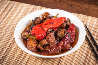 Baharatlı domuz eti ve baharatlı mantar, bambu peçetesinde acı biber, yakın plan.