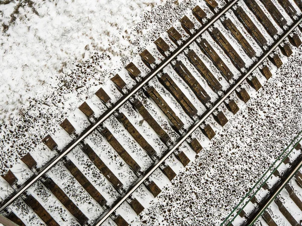 Snow covered railway track in winter, top view - winter background, copy space
