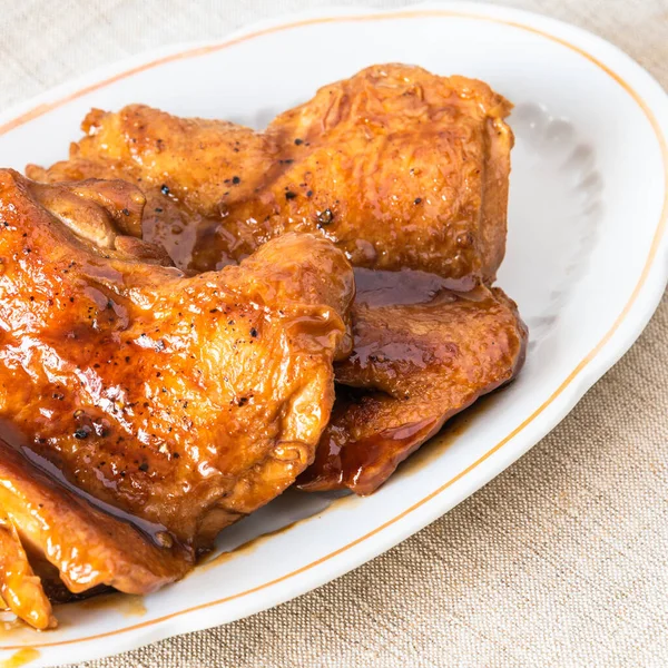 Fried chicken pieces with teriyaki sauce, close-up