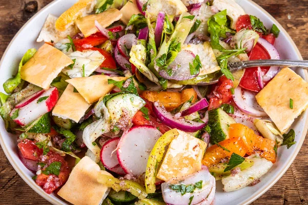 Domatesli, turplu, soğanlı, salatalıklı ve marullu yağlı Arap sebze salatası.