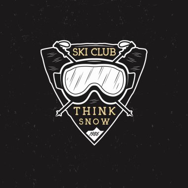 Winter Ski club label design. Sports shield badge with ski equipment goggles and text - think snow. Vintage extreme adventure badge. Travel hipster patch. Wilderness insignia isolate on dark. Vector.