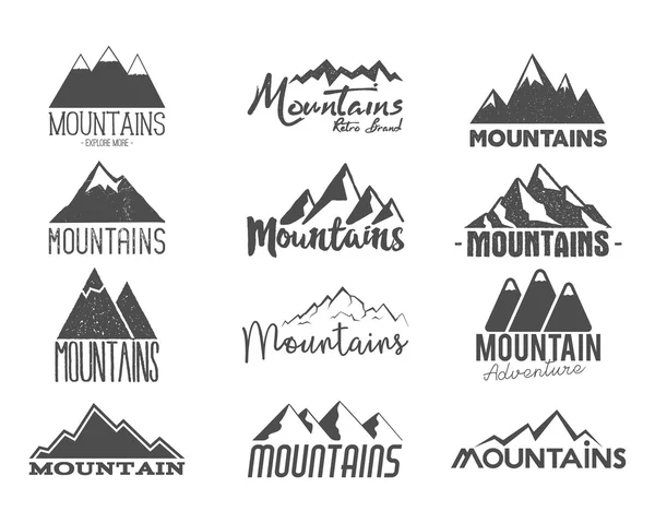 Set of Hand drawn mountains badges. Wilderness old style typography labels. Letterpress Print Rubber Stamp Effect. Retro mountain logo designs. vector Inspirational vintage hipster brand design. — Vetor de Stock