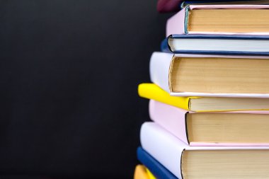 Siyah arkaplan üzerine kitap yığını