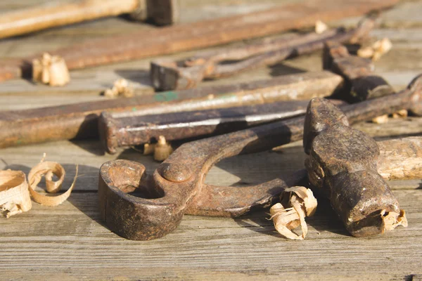 Conjunto oxidado de herramientas manuales sobre un fondo de madera. Foto vintage —  Fotos de Stock