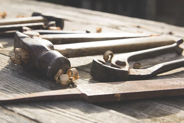 Conjunto enferrujado de ferramentas manuais em um fundo de madeira. Foto vintage — Fotografia de Stock