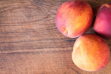 Ahşap kesme tahtası üzerinde taze şeftali.