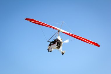 Motorlu hang glider mavi gökyüzünde süzülen