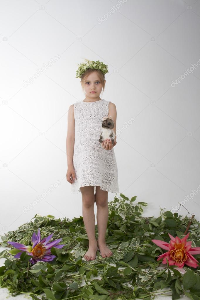 Portrait of the beautiful little girl of the child with a fine wreath on the head