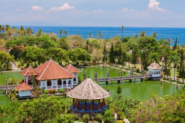 Aerial view of Taman Ujung water palace near Alampura in Karangasem on Bali Island. Ancient palace of Balinese royal family with water pools and tropical landscape park. Indonesian art and culture. clipart