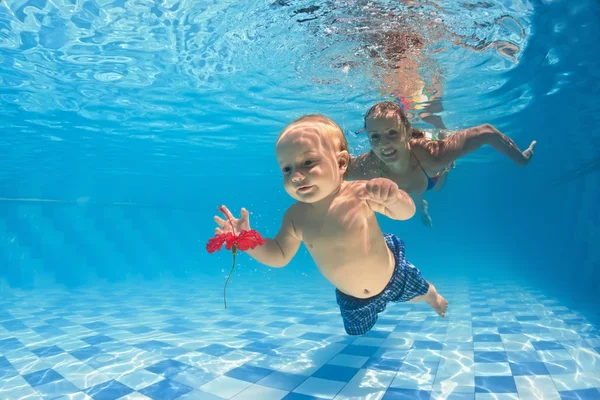 Baby underwater swimming lesson with instructor in the pool — Stock Photo, Image