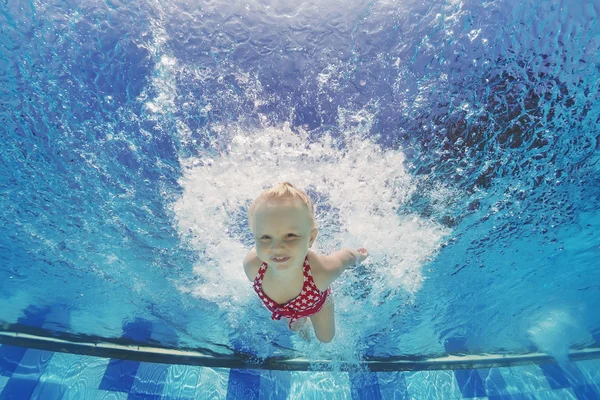 Natação subaquática com salpicos na piscina de criança — Fotografia de Stock