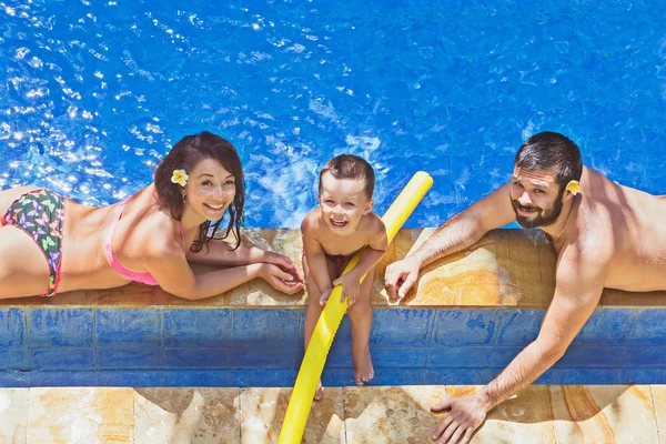 Positive family relax in the outdoor tropical pool — Stock Photo, Image