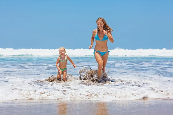 Happy mother with child swim with fun in sea surf — Stock Photo, Image