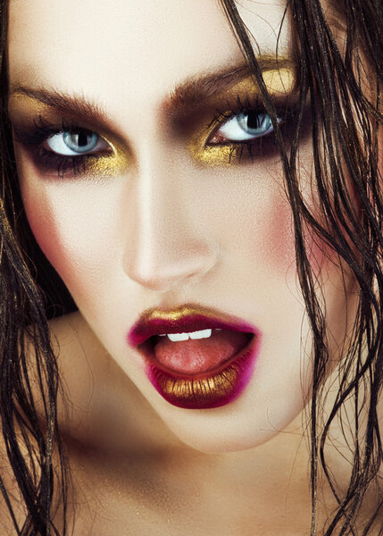 sexy woman with gold make-up and wet hair