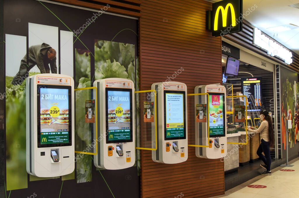 Wall terminals for ordering at McDonald's. New reality: minimal contact when serving in restaurants and fast food cafes. Service for customers to speed up service in cafe. Moscow Russia-12.20.2020
