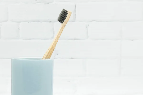 Bamboo Wooden Toothbrushes Black Bristles Blue Glass White Brick Wall — Stock Photo, Image