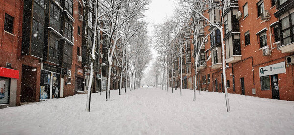 Madrid, Spain- January 9, 2021: Streets of Madrid blocked by snow, Storm Filomena. Great snowfall in Madrid. Snow covered cars.
