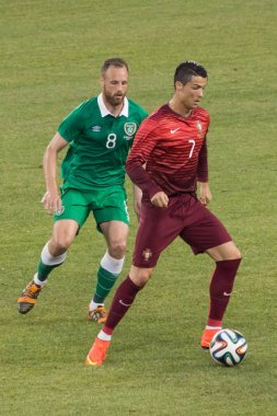 Cristiano Ronaldo dribbling the ball during a pre-World Cup 2014 friendly match versus Ireland at MetLife stadium -Summer 2014 clipart