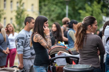 Brno, Czech Republic. 06-11-2016. Woman with baby at a Festival of Roma people (Gypsies) in Brno attended by people from the community, with activities for children and adolescents. clipart