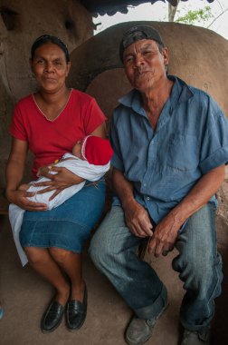 Rivas, Nicaragua. 07-15-2016. Grandparents and their grand daughter in their house in an rural area of Nicaragua. clipart