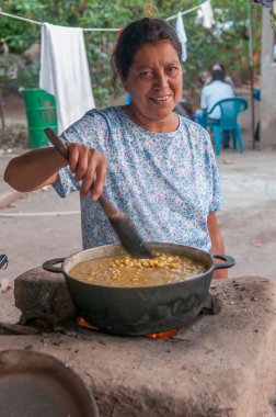 Rivas, Nicaragua. 07-15-2016. A woman is cooking a typical Nicaraguan food in Rivas, an rural areas of Nicaragua. clipart