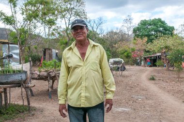 Rivas, Nicaragua. 07-15-2016. Portrait of a farmer in an rural area of Nicaragua. Families rely on raising cattle an vegetable growth for survival. clipart