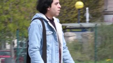 Prag, Çek Cumhuriyeti. 04-16-2021. Genç yetişkin erkek Prag şehir merkezindeki Hradcanska demiryollarından geçiyor..