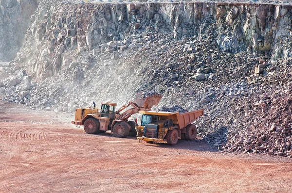 Excavatrice chargeant le camion benne dans une mine de carrière . — Photo