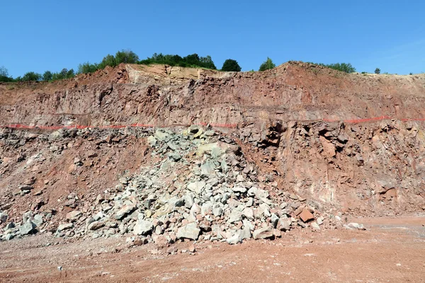 view into an open pit mine with prophyry rock material