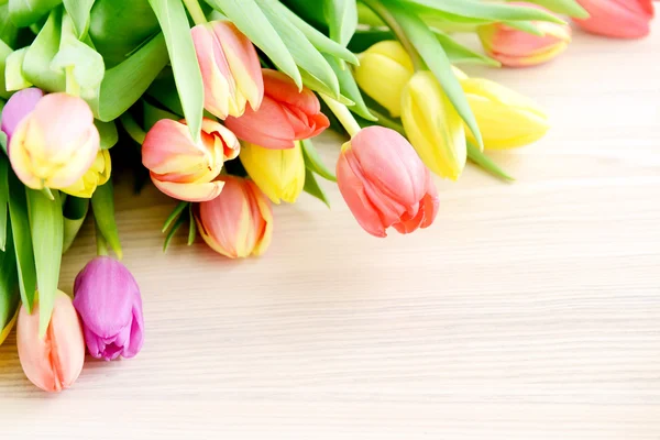 Bunch of tulips on white wooden background — Stock Photo, Image