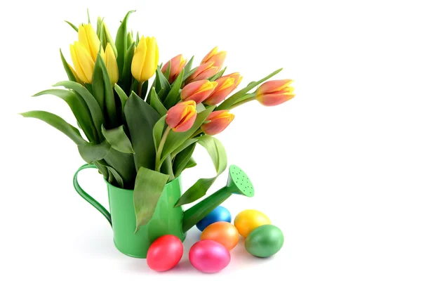 Ovos de Páscoa em torno da água pode vaso com tulipas — Fotografia de Stock