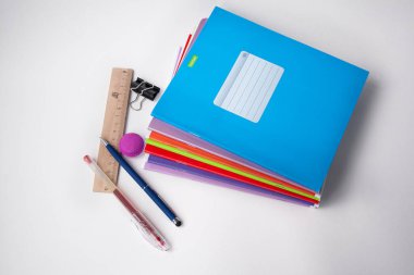 Hafif arkaplanda defterler ve kalemler