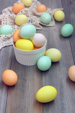 Ahşap döşeme üzerinde renkli yumurta ile Paskalya natürmort.