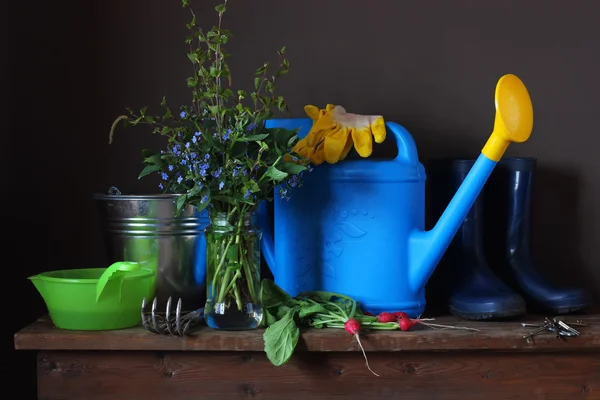 Zátiší jarní kytice, ředkvičky a zahradní vybavení. — Stock fotografie